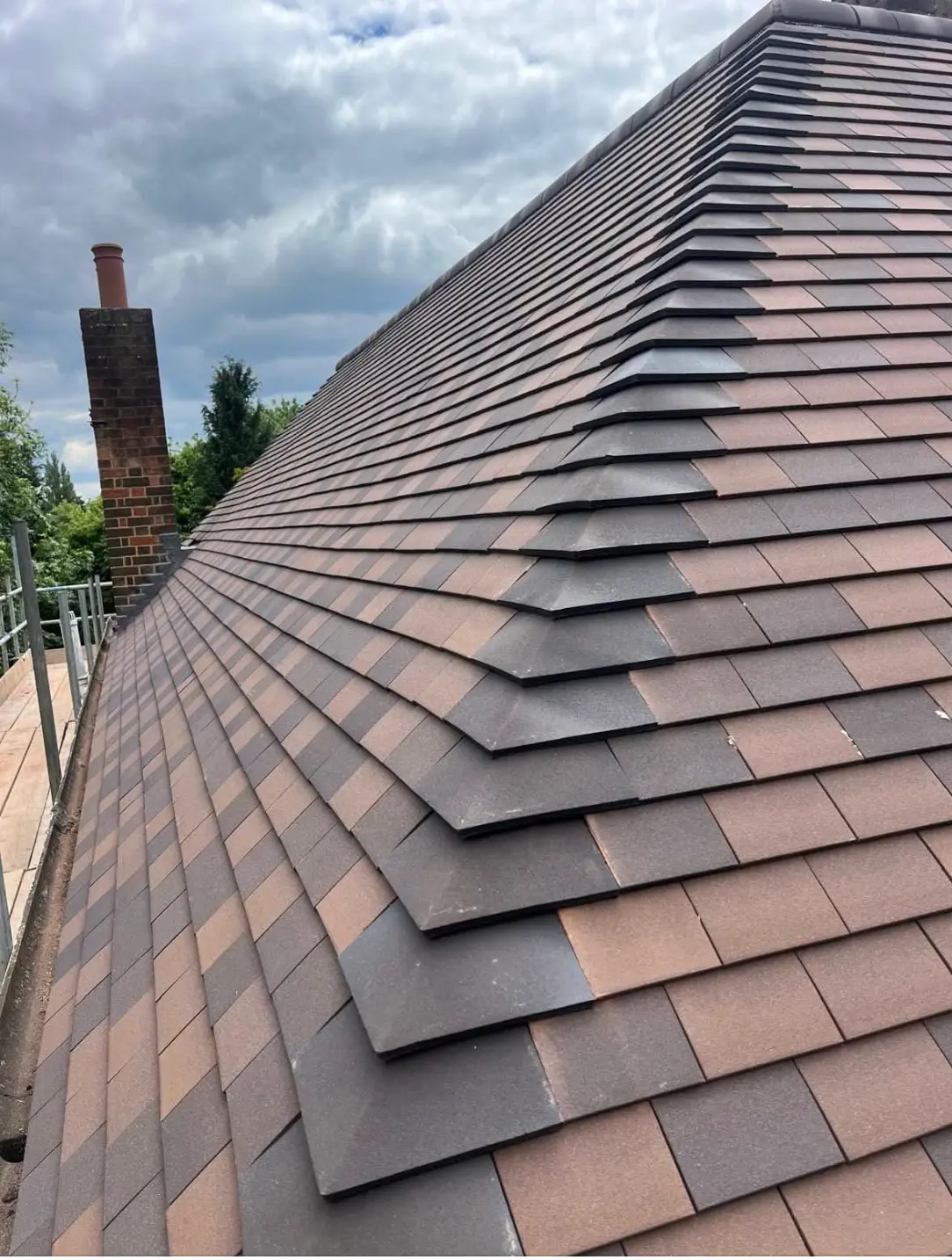 Close view of new hip tiles running down a newly tiled roof towards the eaves