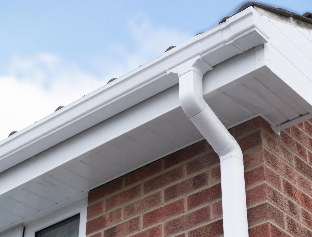 New white fascia and soffit boards fitted along a house roofline