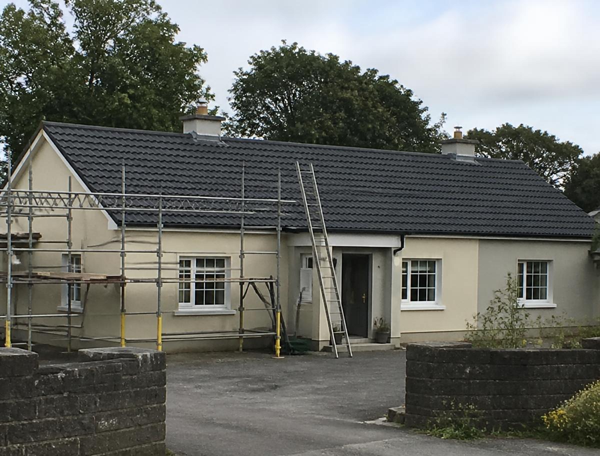 Completed new tiled roof on a bungalow with scaffolding still in place